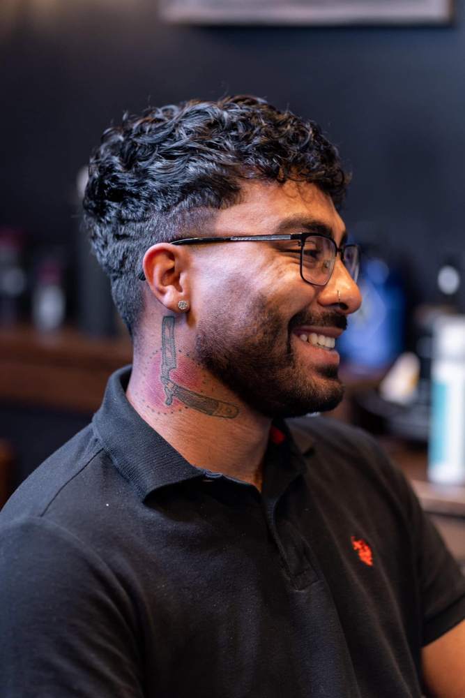 Burst fade around the ear with a clean neckline at The Cave, Rogers AR